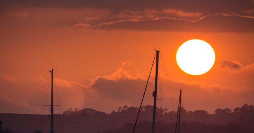sunset behind a yacht