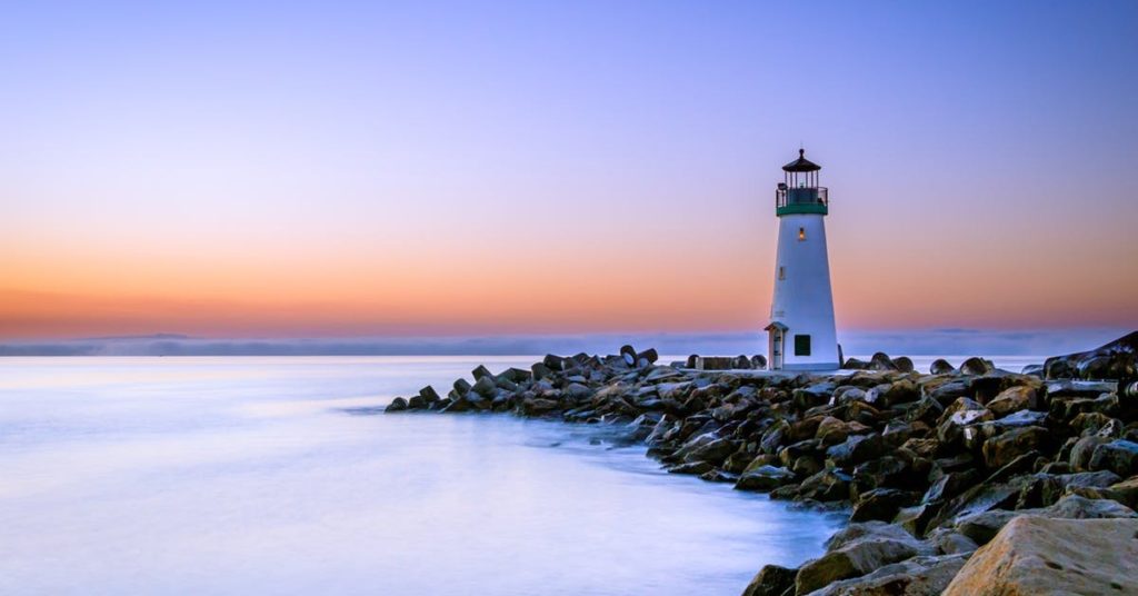 white lighthouse at beach