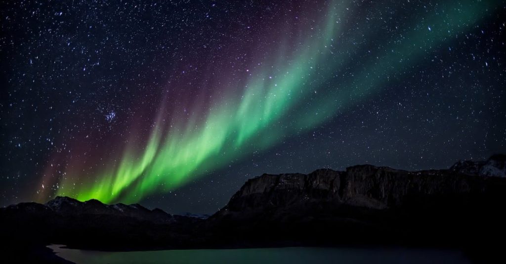 northern lights in the night sky with mountains
