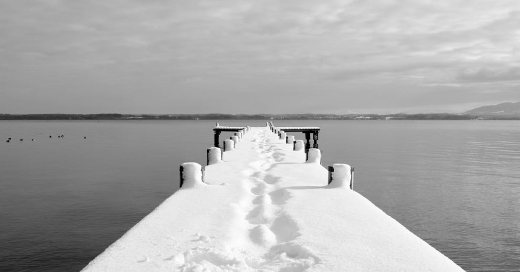 snow covered dock looking out on the water