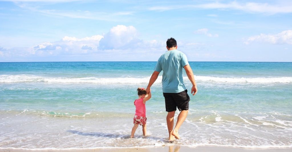 dad and child at the beach
