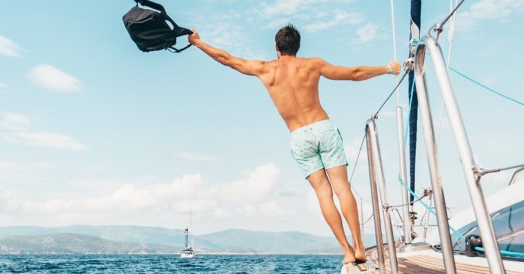 man on sailboat waving