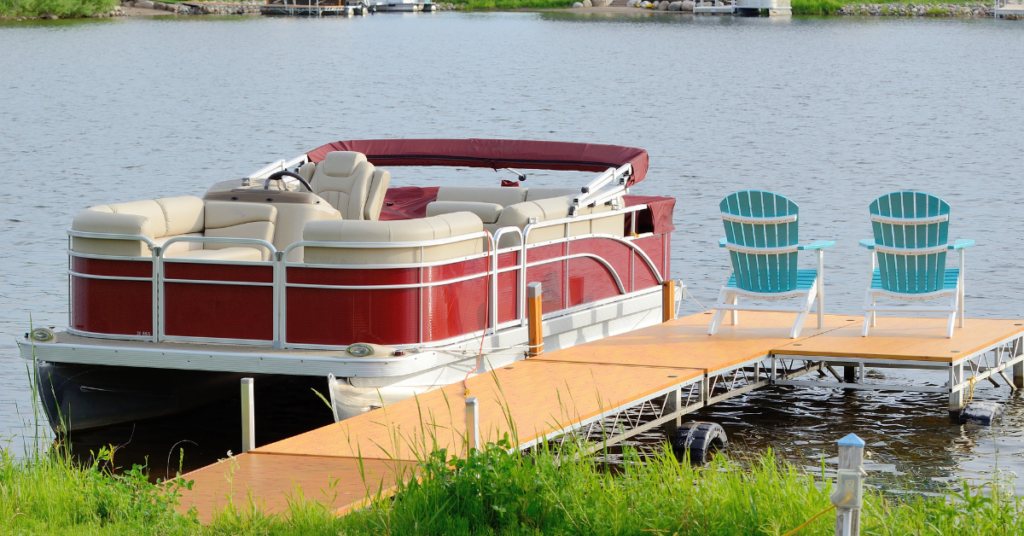 Pontoon Boat docked next to chairs.