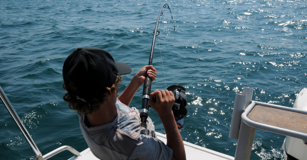 A man fishing off of a luxury fishing boat.